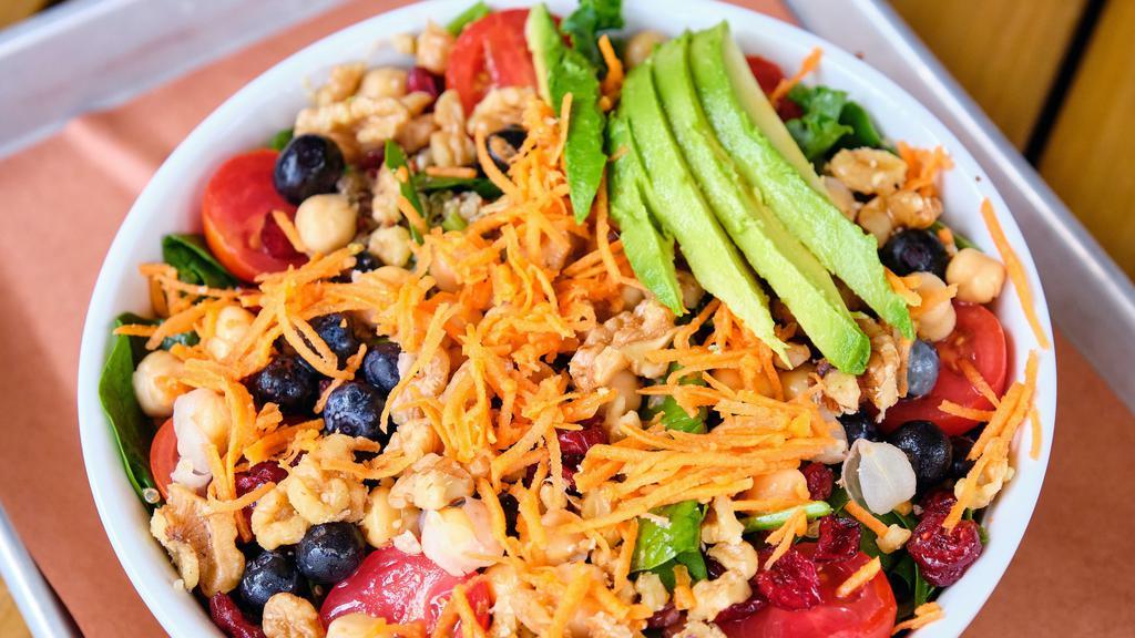 Superfoods Bowl · All the good stuff in one bowl! Kale and spinach are mixed with quinoa, cherry tomatoes, chopped walnuts, fresh blueberries, dried cranberries, garbanzo beans, and shredded carrots. Maple vinaigrette goes best.