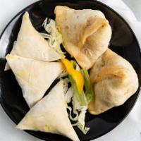 Vegetable Samosa 2 Pieces · Triangular puffed pastry filled with potatoes, carrots, peas and herbs.