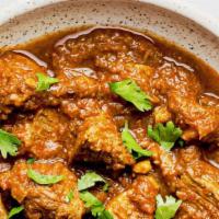 Goat Curry · Goat meat sauteed in India’s favorite yellow curry sauce cooked with grilled onions, turmeri...