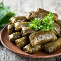 Dolmades Armenia · Tender grape leaves, stuffed with ground turkey, our house seasonings and rice and gently bo...