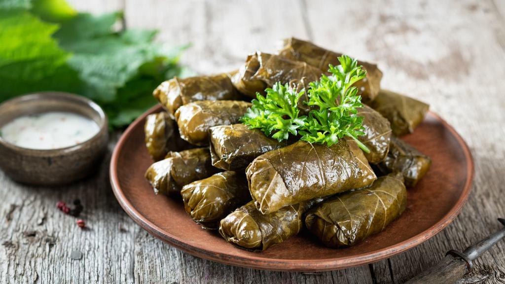 Dolmades Armenia · Tender grape leaves, stuffed with ground turkey, our house seasonings and rice and gently boiled to perfection. Served with our homemade tzatziki
sauce.