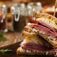 Pastrami Yummy Sandwich · Mammoth sandwich with piles of house-cured
pastrami (whole brisket, cured, smoked and
pressu...