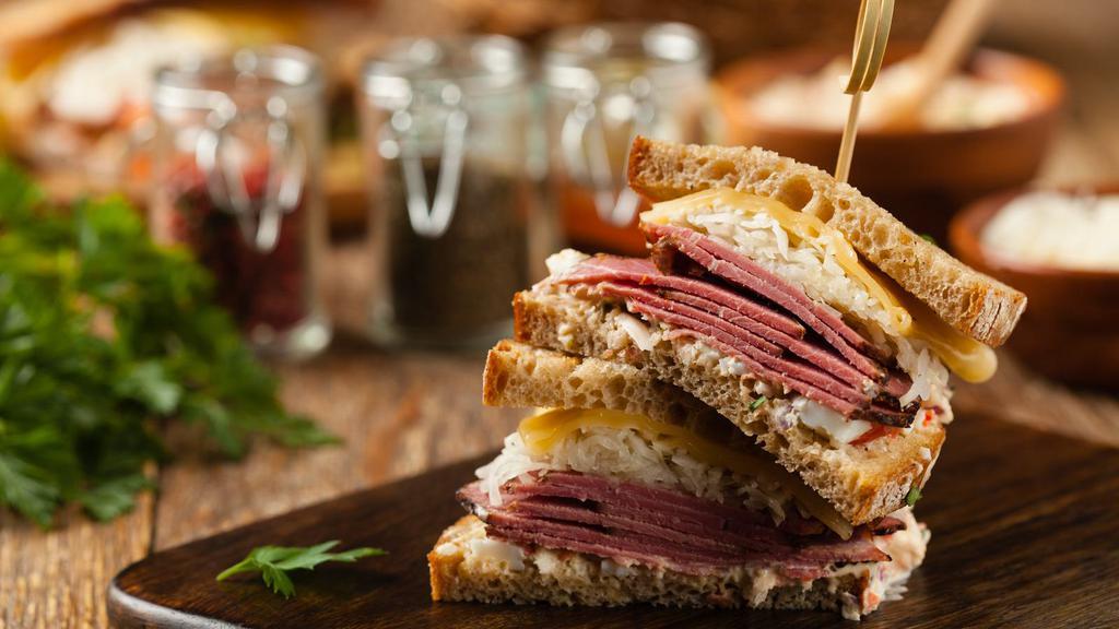 Pastrami Yummy Sandwich · Mammoth sandwich with piles of house-cured
pastrami (whole brisket, cured, smoked and
pressure cooked). Served with Swiss cheese, our homemade sauerkraut, homemade aioli Taiga, fresh pumpernickel bread and pickles, and your
choice of authentic sides.