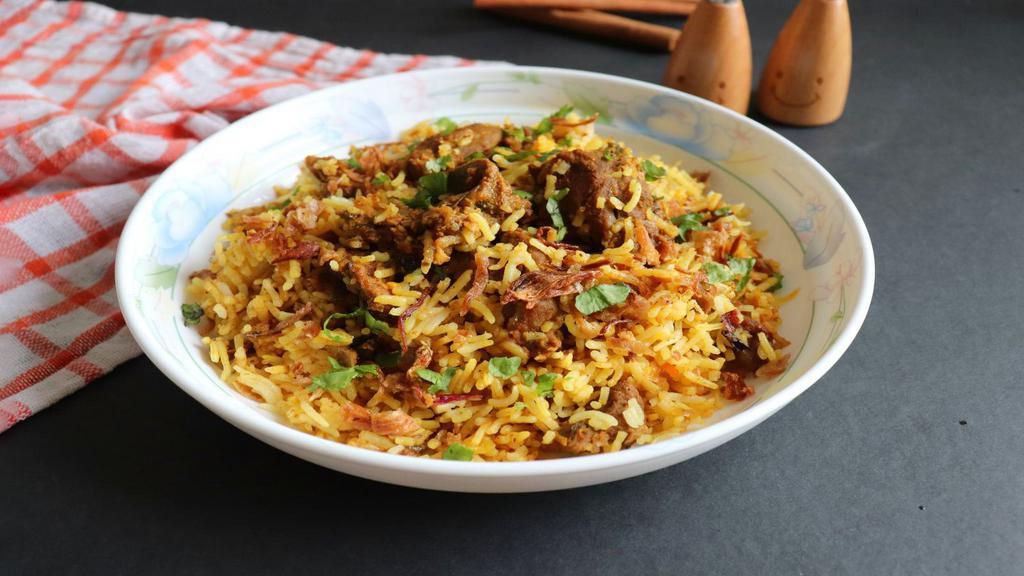 Plov Uzbekistan · Incredibly satisfying. Pilaf-type dish made with long grain rice, tender chunks of lamb, onions, raisins, and carrots, slow-cooked in savory lamb broth until perfectly tender. Served with side of lamb meat, fresh tomato, and cucumber salad.