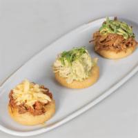 Arepita Sampler · 3 mini Arepitas crowned with our Favorite Toppings: Shredded Beef with Yellow Cheese, Pernil...