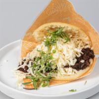 Arepa Domino · Grated white cheese and black beans.