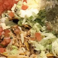 Nachos Supreme · Choice of ground beef or shredded chicken, topped with beans, lettuce, tomatoes, and sour cr...