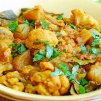 Aloo Gobi · Lightly boiled cauliflower and potatoes with tomatoes cooked with cumin and spices.