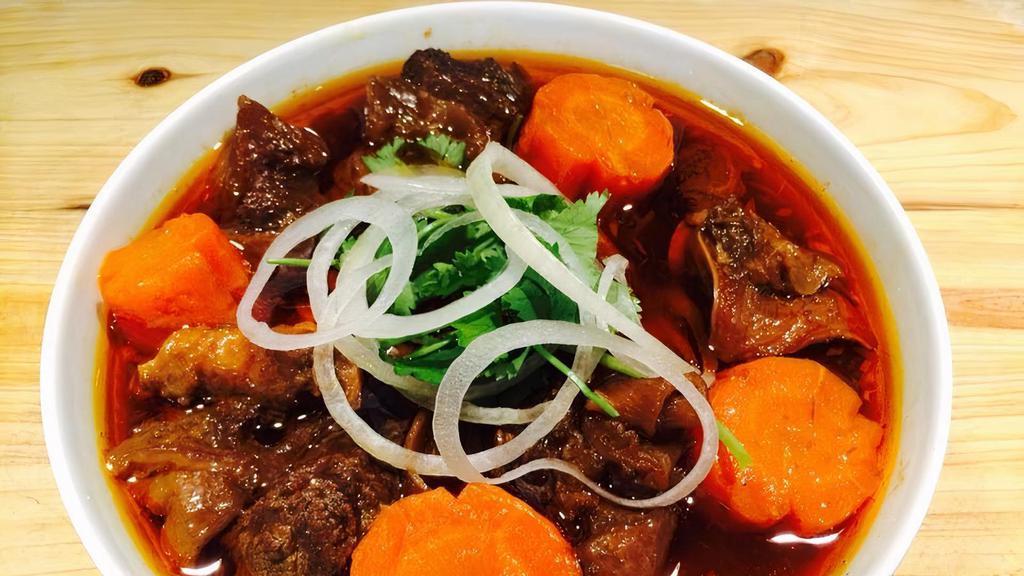 Beef Stew · Beef stew topped with beef cube, potato, carrot, onion and your choice of side dish: steamed rice, egg noodle or crunchy banh mi.