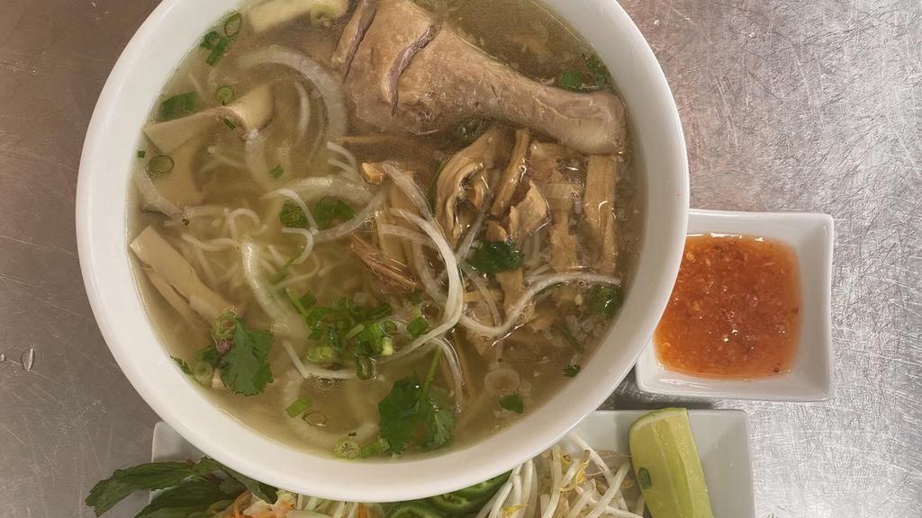 Bún Măng Vịt - Duck Noodle Soup · Rice vermicelli duck noodle soup with bamboo shoots, thin slices of white onions, green onions, garnished with shredded cabbage, cilantro, basil, bean sprout, jalapeño, lime and ginger fish sauce.