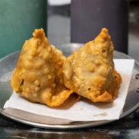 Vegetable Samosa (2) · Triangular pastries stuffed with potatoes and green peas, with a hint of spices.