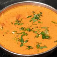 Chicken Tikka Masala · Tender chicken breast marinated in spices and yogurt, baked in clay oven and cooked in a tom...