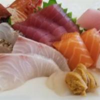 Sashimi Deluxe · Chef's choice 18 pieces sashimi, eight pieces spicy tuna roll. Raw.