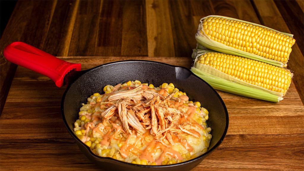 Maicito De Pollo · Most popular Sweet corn mixed with shredded chicken breast, soft, melted mozzarella cheese, Pink sauce, crushed potato chips, and finished with the special sweet touch of our pineapple sauce on top!