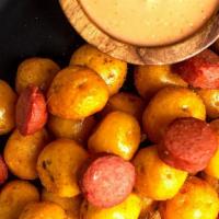 Salchipapa Criolla · Deep Fry Imported Colombian Yellow potatoes and  Nathan's Famous Premium Beef Sausage!