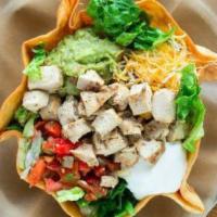 Tostada · A crispy flour tortilla shell filled with romaine lettuce, Mexican rice, black or pinto bean...