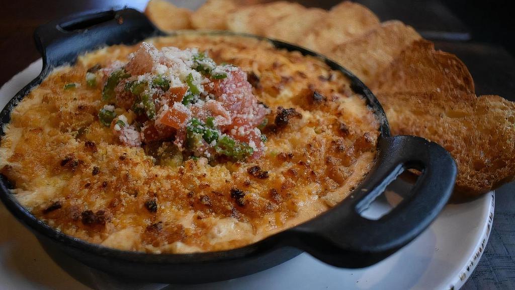Creole Seafood Dip · Cream cheese dip loaded with shrimp,. crawfish, and blue crab topped with a. hushpuppy parmesan crumble.