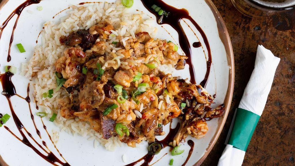 Voodoo Chicken · Grilled chicken with a creamy reduction of wine, caramelized onions, bacon and crawfish with our sweet balsamic glaze. Served over white rice.