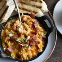 Crawfish Mac N' Cheese · Louisiana crawfish tails baked in an iron skillet with creamy cheddar sauce, rotini pasta, s...