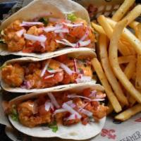 Fire Shrimp Tacos · Flour tortillas stuffed with fried shrimp and topped with fresh pico de gallo and our creamy...