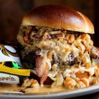 Voodoo Burger · ½ lb brisket burger with Tabasco bacon, cheddar, and pickles smothered with caramelized onio...