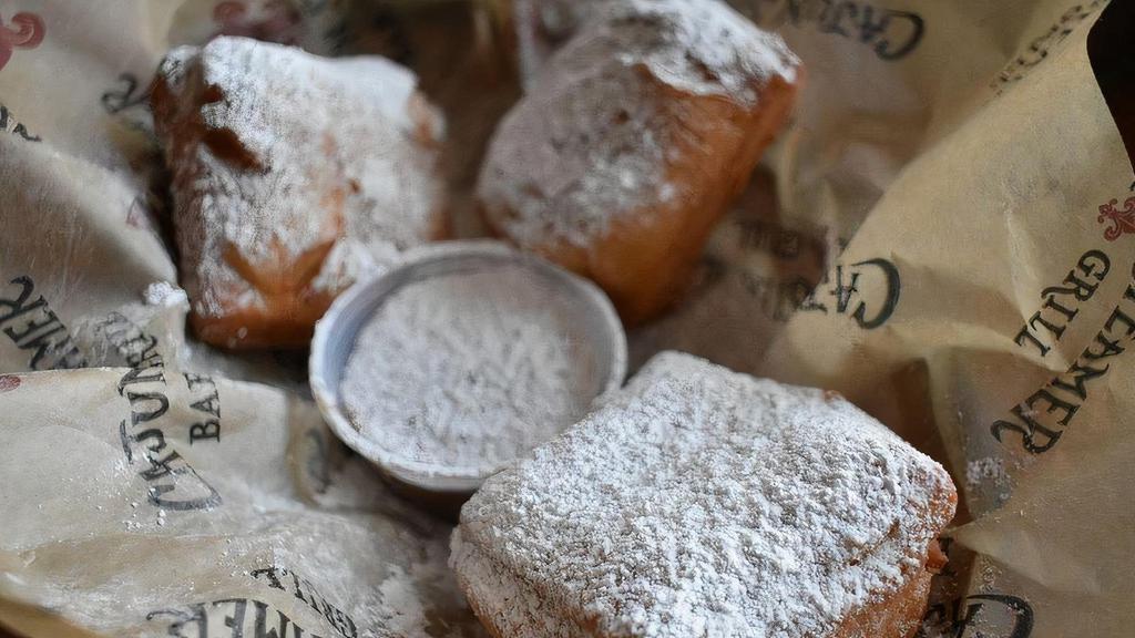 Beignets · French Quarter classic dusted with plenty of powdered sugar and served with a bourbon caramel dipping sauce