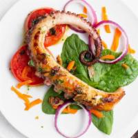 Octopus · Poached, pan seared and finished in the oven in a garlic-herb sauce. Gluten-free.