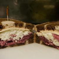 The Village Reuben · Hot corned beef or pastrami on seeded rye topped with Swiss cheese, coleslaw, and 1000 Islan...