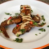 Alitas (5) · All Natural Chicken Wings,. Spicy Beer Eel Reduction, Tahini Sauce