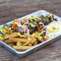 Lomo Saltado · Tenderloin, rice, French fries, tomatoes, pickled onions, huancaina