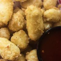 Beer-Battered Cheese Curds · Fried Wisconsin white cheddar bites, red pepper jam.