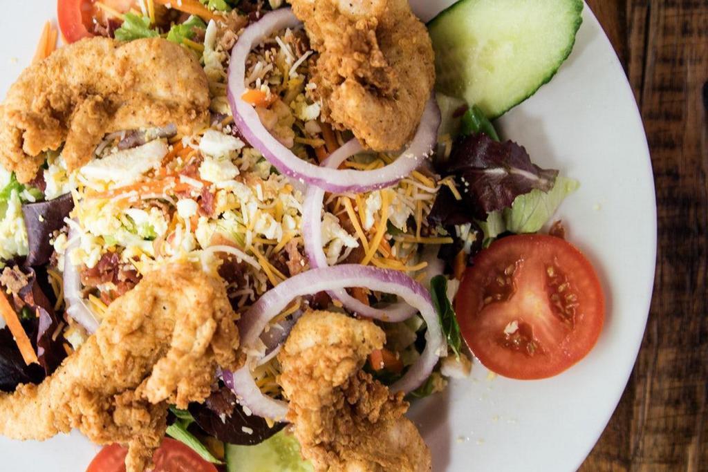 Southern Fried Chicken Salad · Crispy chicken tenders, tomato, cucumber, carrot, hard-boiled egg, bacon, , croutons, cheddar & mozzarella cheese, red onion, mixed greens.