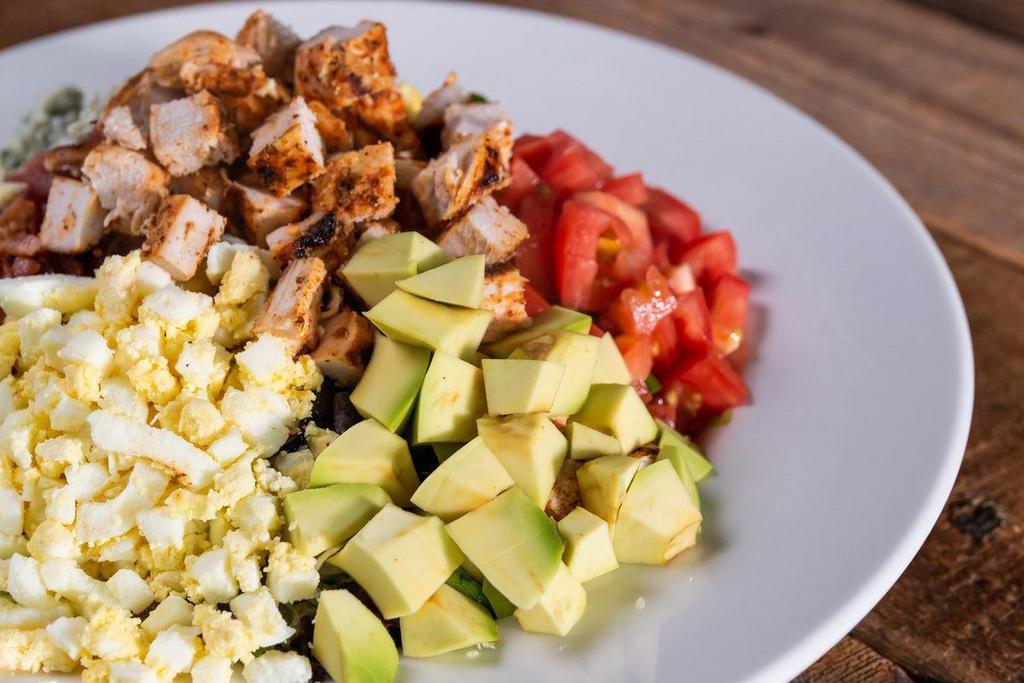Grilled Chicken Cobb Salad · (Available til 11pm) Fresh avocado, roasted corn salad, tomato, hard-boiled egg, crispy smoked bacon, blue cheese crumbles, romaine.