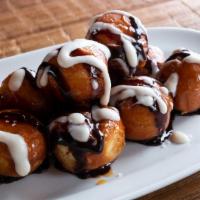 Macked Out Doughnuts · Doughnut holes tossed in cinnamon sugar, Ghirardelli chocolate, and caramel drizzle.