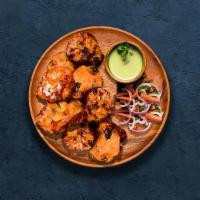 Chicken Tikka  · 6 pieces of tender chicken marinated in yogurt, glazed in a traditional Indian clay oven.