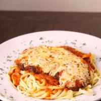 Chicken Parmigiana · Breaded chicken breast baked with marinara sauce and mozzarella cheese on top.