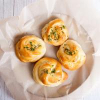 Garlic Knots · Knots freshly baked with a savory blend of fresh garlic, virgin olive oil, oregano and parsl...