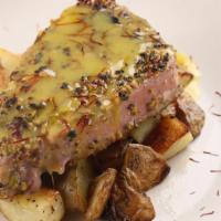 Tonno · Pistachio-crusted seared fresh tuna fish with saffron emulsion served with roasted potatoes.