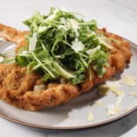 Orecchia D'Elefante (Veal) Original Milanese · Butterflied bone-in veal chop Milanese style served on a bed of fresh baby arugula, shaved P...