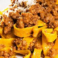 Bolognese · Tagliatelle pasta sautéed with our very traditional bolognese-style meat sauce and Parmigian...