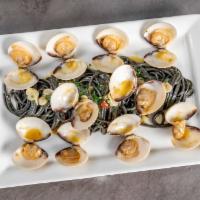 Vongole · Squid ink spaghetti sautéed with clams in white wine sauce with a touch of spicy love.<br />