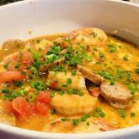 Shrimp & Grits · Creole sauce, smoked gouda stone ground grits, scallions.
