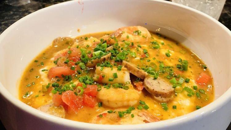 Shrimp & Grits · Creole sauce, smoked gouda stone ground grits, scallions.