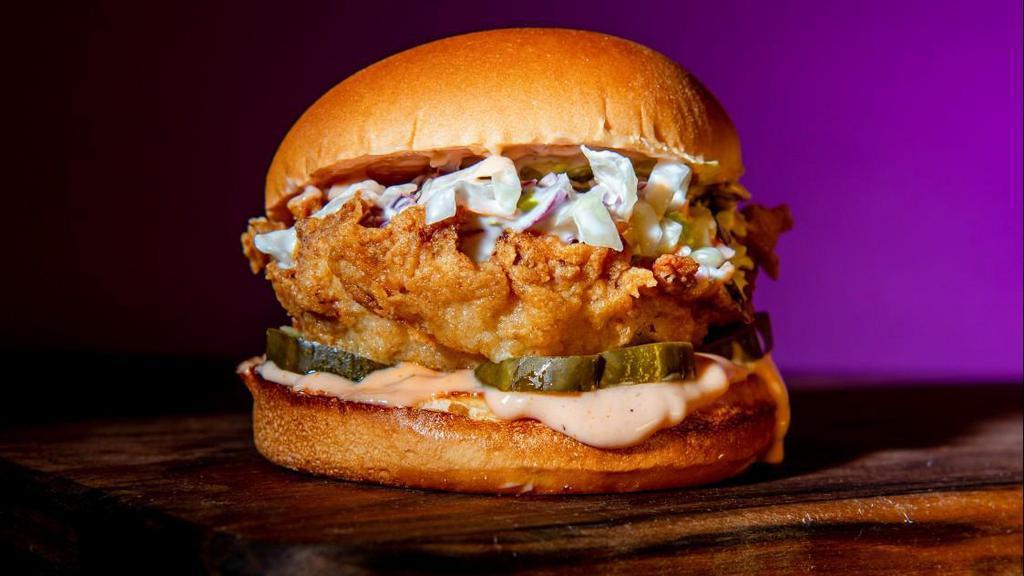 Classic Fried Chicken Sandwich · Southern fried and hand breaded chicken breasts seasoned in our signature New Orleans style spice in between a toasted brioche bun with coleslaw, pickles, classic sauce.