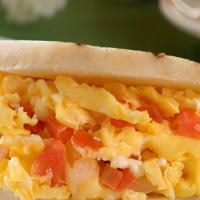 Arepa De Perico · Corn arepa filled a scrambled omelet with tomatoes and onion.