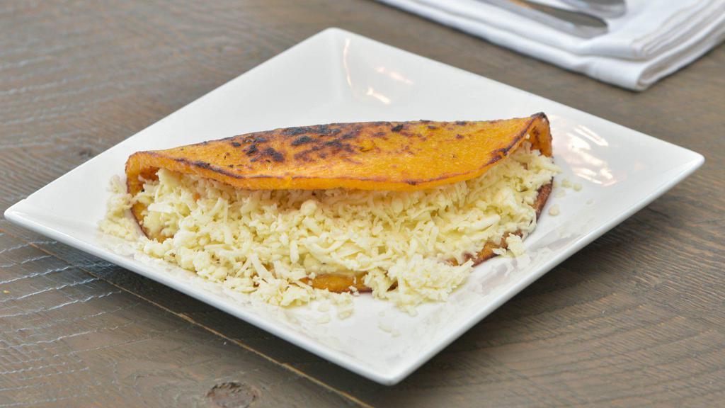 Cheese Cachapa · Corn cake made of fresh corn cooked in a budare (a clay or iron plate) served with fresh shredded white cheese.