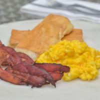 Completa · Two eggs any style, choice of ham or bacon tostada, and cafe con leche.