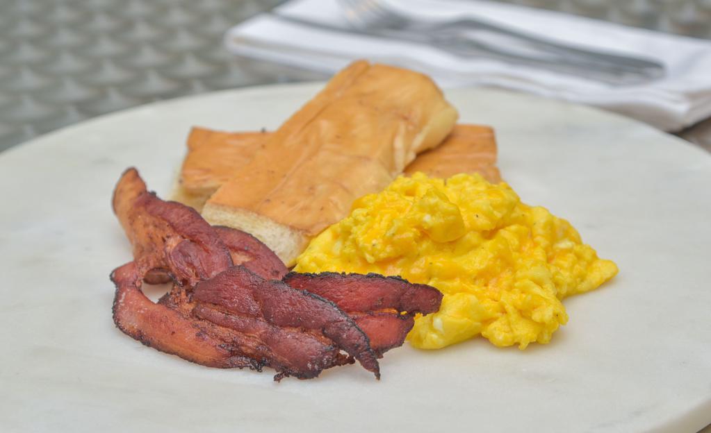 Completa · Two eggs any style, choice of ham or bacon tostada, and cafe con leche.