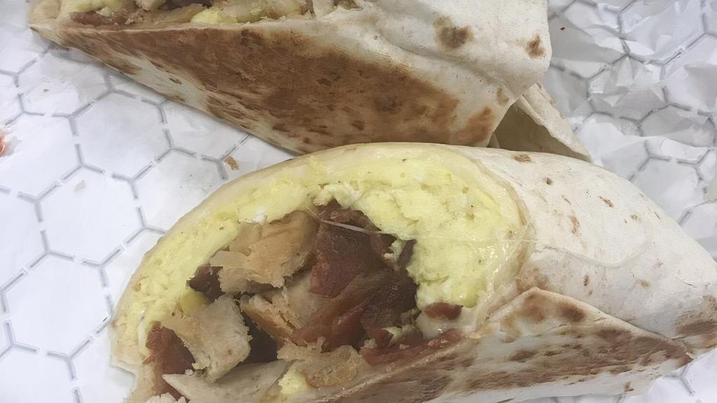 Completa Wrap · Two eggs any style, choice of ham or bacon, tostada in a wrap.