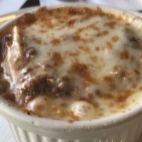 Petite Lasagna · Oven-baked layers of pasta, béchamel, and Bolognese sauce. Served with a small house or Caes...